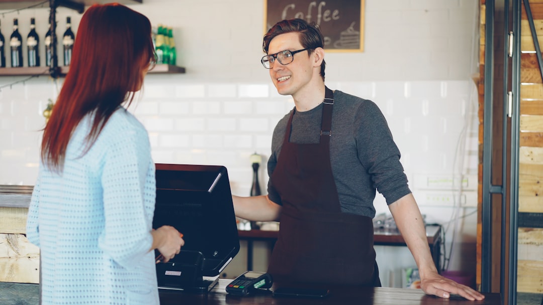 A barista takes an order from a customer.