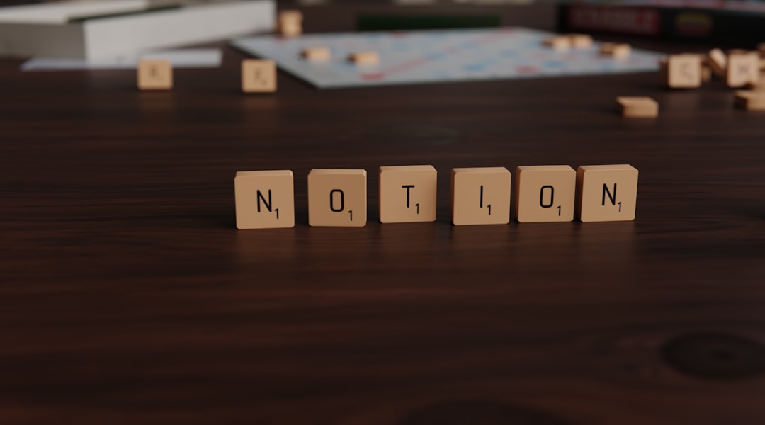 Scrabble tiles spell out the word "notion" on table.