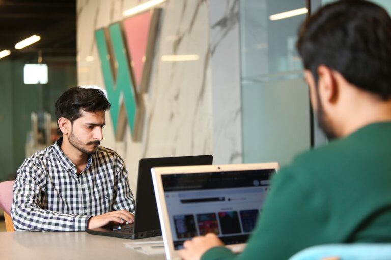 a man sitting in front of a laptop computer