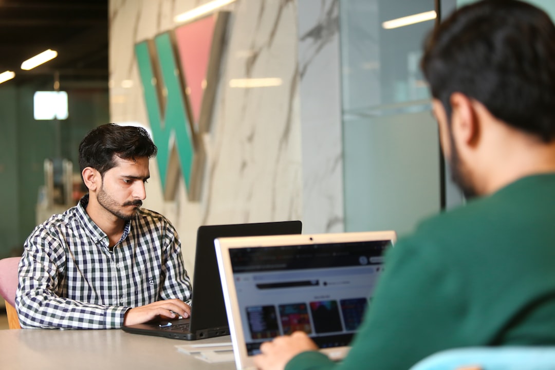 a man sitting in front of a laptop computer